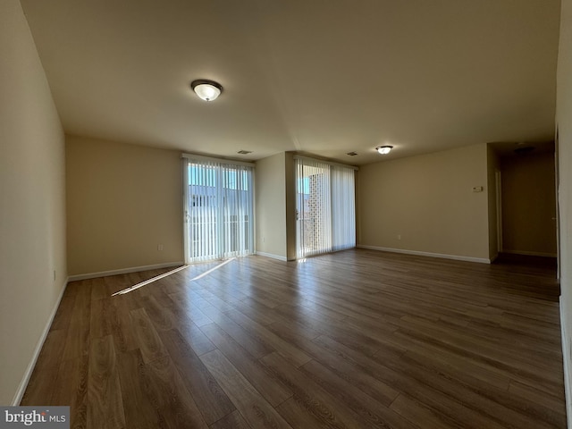 unfurnished room featuring dark wood-type flooring