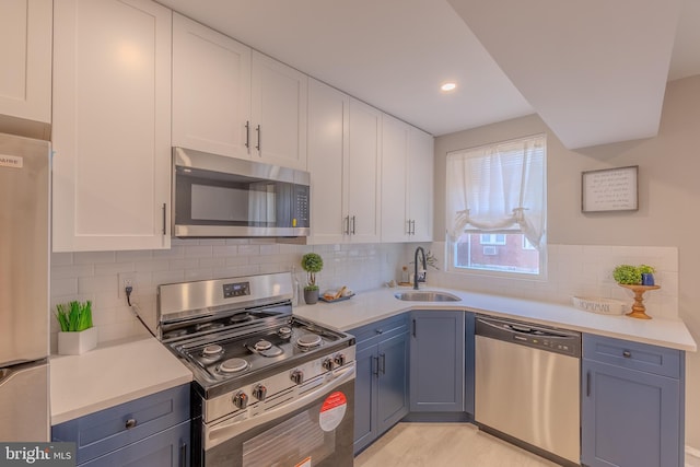 kitchen featuring white cabinetry, stainless steel appliances, sink, and tasteful backsplash