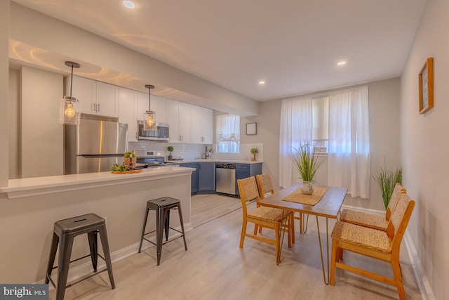 dining room with light hardwood / wood-style flooring and sink