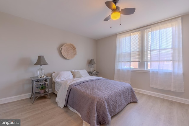 bedroom with light hardwood / wood-style floors and ceiling fan