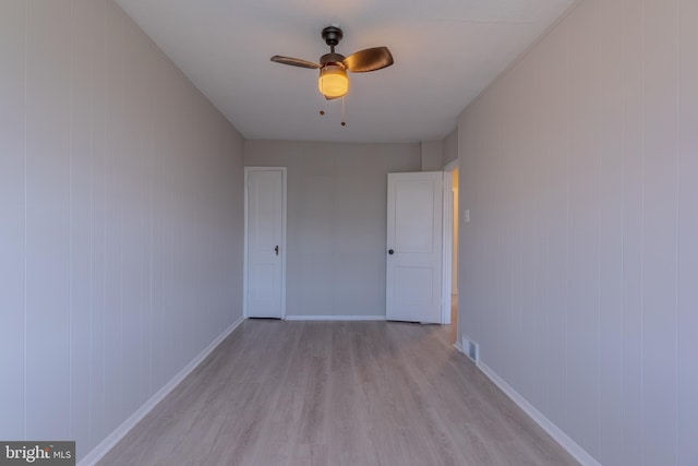 empty room featuring light hardwood / wood-style flooring and ceiling fan