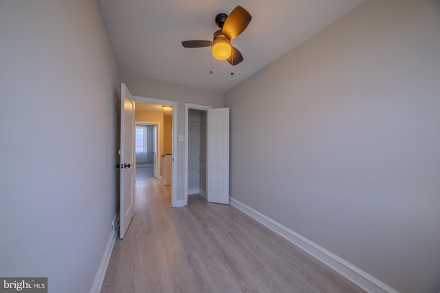 unfurnished bedroom featuring ceiling fan and light hardwood / wood-style flooring