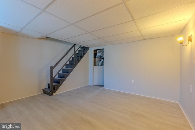 basement with wood-type flooring and a drop ceiling