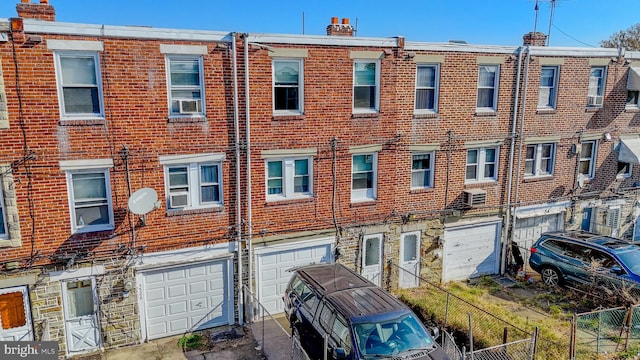 view of property featuring a garage and cooling unit