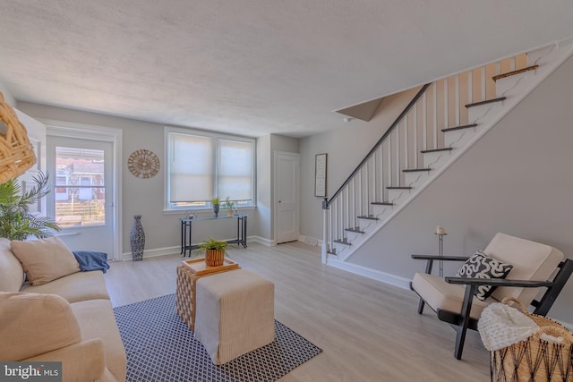 living room featuring light hardwood / wood-style floors and a textured ceiling