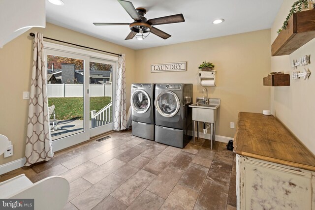 laundry area featuring ceiling fan, washer and dryer, and sink