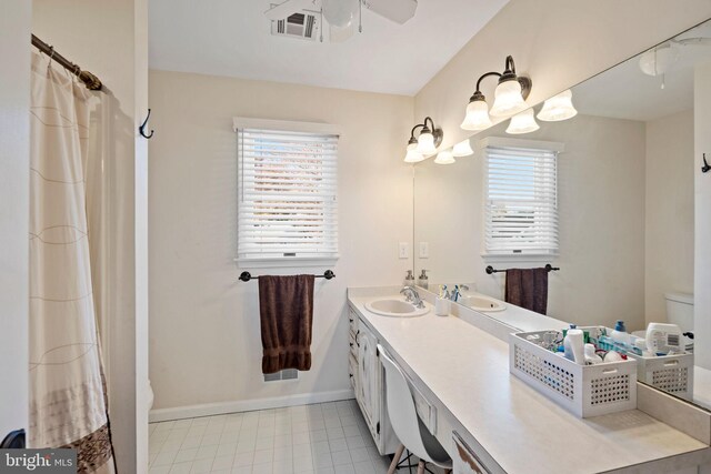 bathroom with ceiling fan, vanity, and toilet