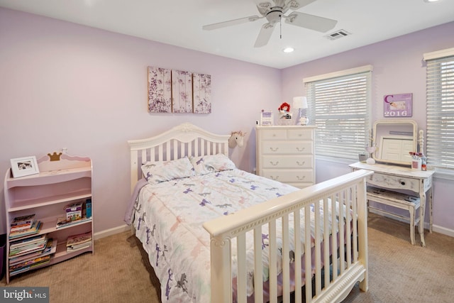 bedroom with ceiling fan, multiple windows, and light colored carpet