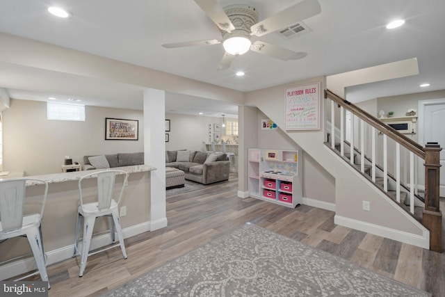 game room featuring hardwood / wood-style flooring and ceiling fan