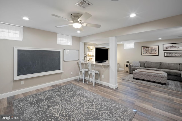 living room with hardwood / wood-style flooring and ceiling fan