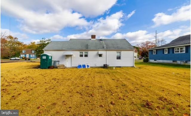 rear view of property with a lawn