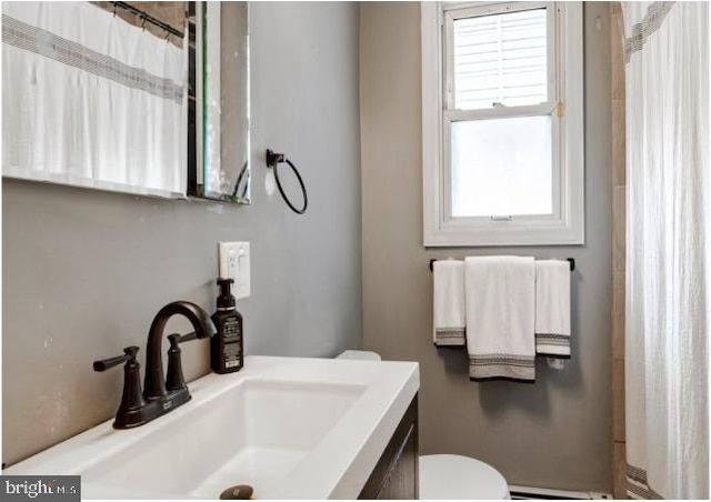 bathroom with toilet and vanity