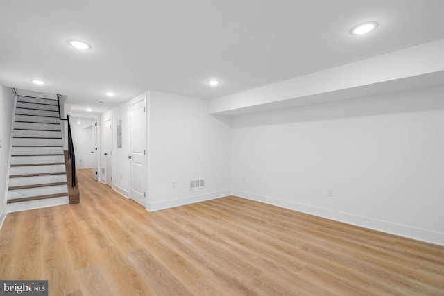 basement with light hardwood / wood-style flooring