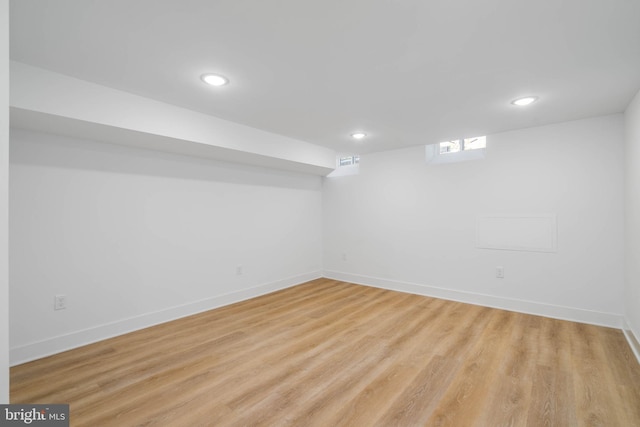 basement with light hardwood / wood-style flooring