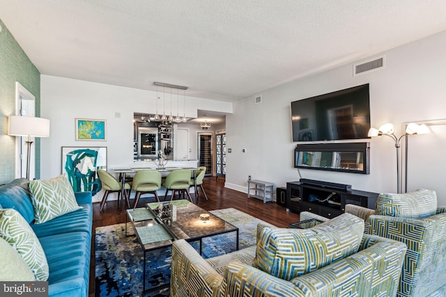 living room featuring dark hardwood / wood-style flooring and a textured ceiling