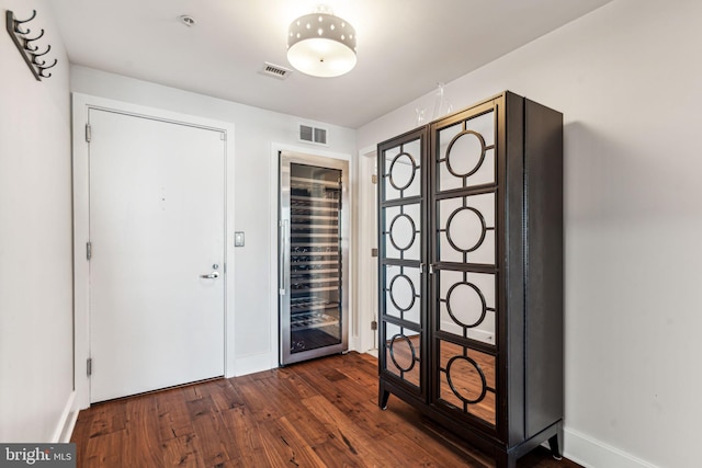 foyer with dark hardwood / wood-style flooring and beverage cooler