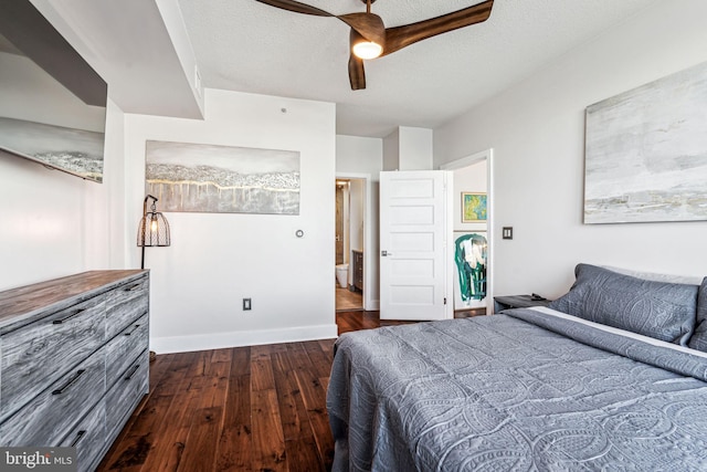 bedroom with a textured ceiling, dark hardwood / wood-style flooring, and ceiling fan