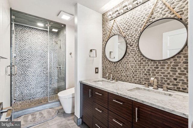 bathroom featuring vanity, toilet, backsplash, and walk in shower