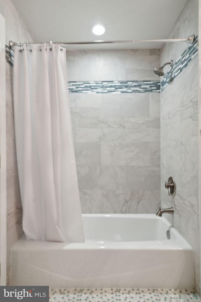 bathroom with shower / bathtub combination with curtain