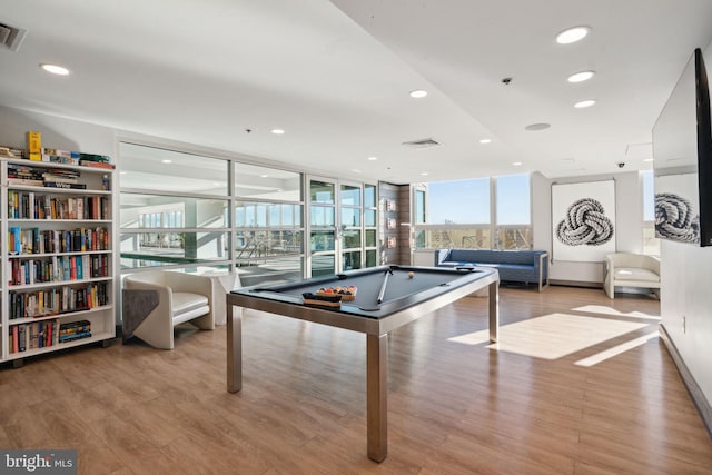 rec room with floor to ceiling windows, light hardwood / wood-style floors, and pool table