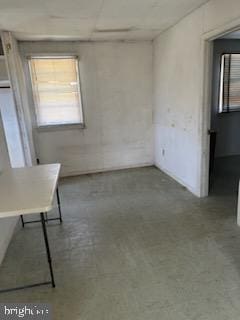 unfurnished room featuring concrete flooring