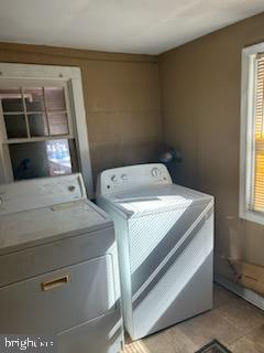 clothes washing area featuring washer and clothes dryer