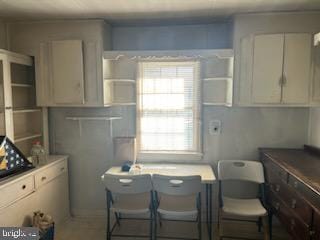 kitchen featuring white cabinetry and a kitchen breakfast bar