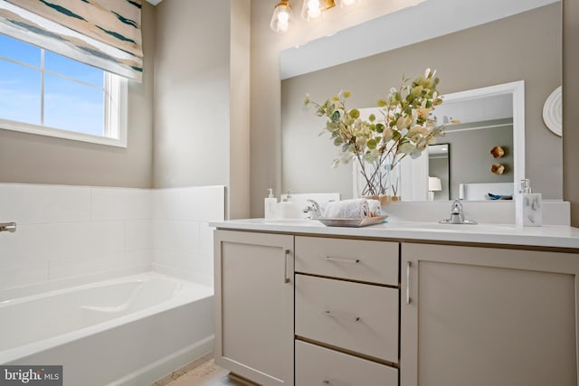 bathroom featuring vanity and a tub