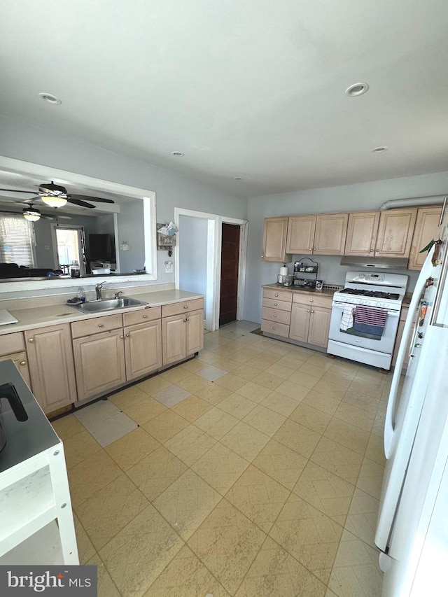 kitchen featuring light brown cabinetry, white appliances, sink, and ceiling fan