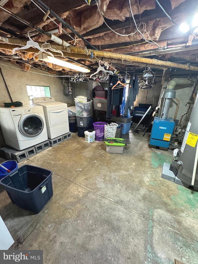 basement featuring washing machine and dryer and water heater