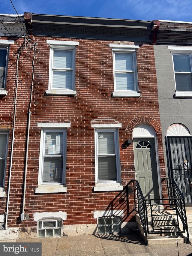 view of property featuring brick siding