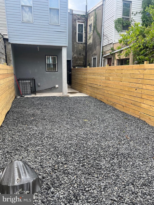 view of yard with fence and a patio