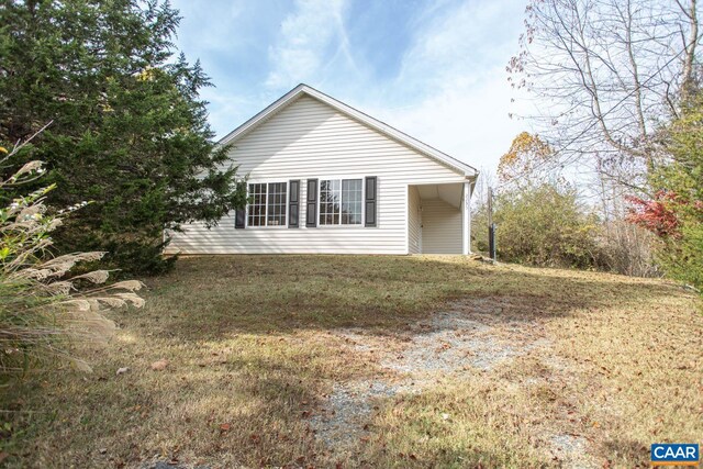 view of side of home with a lawn