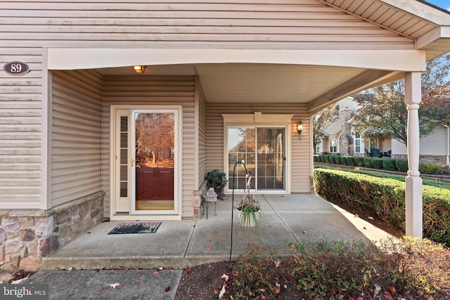 property entrance featuring a patio area