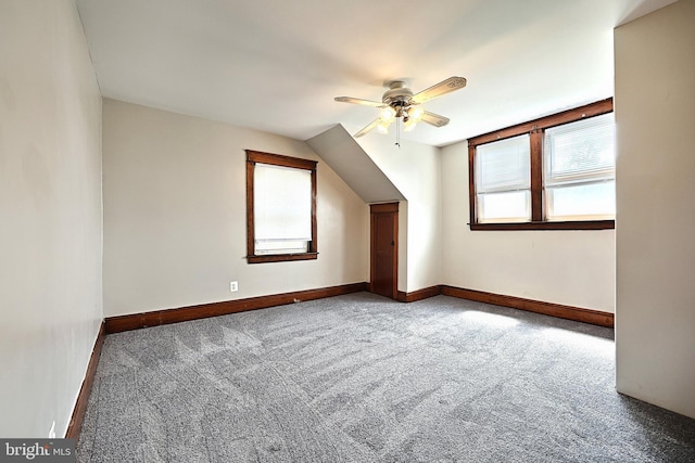 bonus room with ceiling fan and carpet flooring