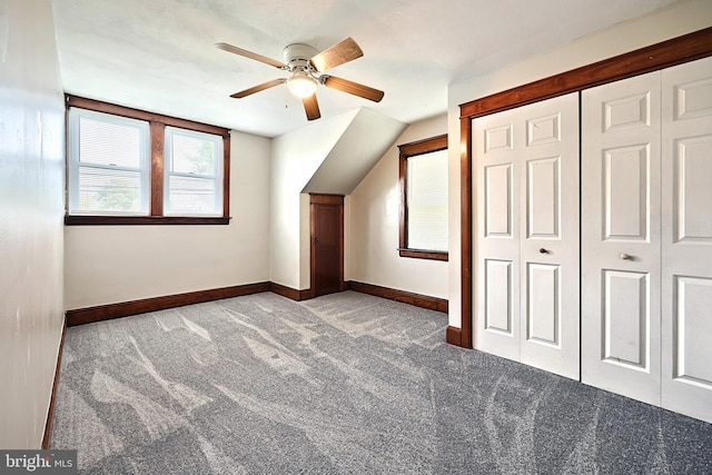 additional living space featuring light carpet and ceiling fan