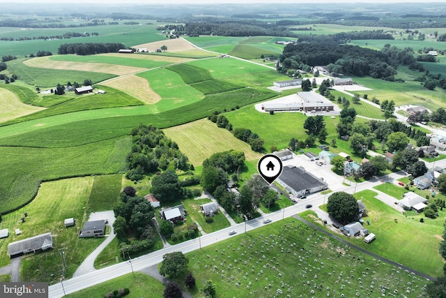 birds eye view of property with a rural view