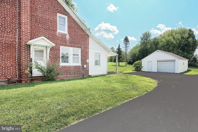 view of property exterior featuring a garage, an outdoor structure, and a yard