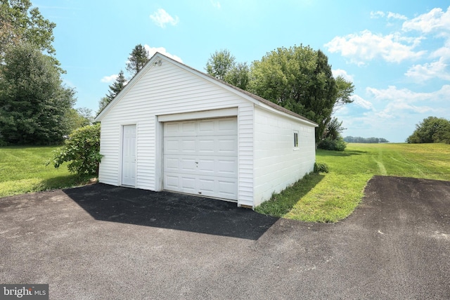 garage featuring a lawn