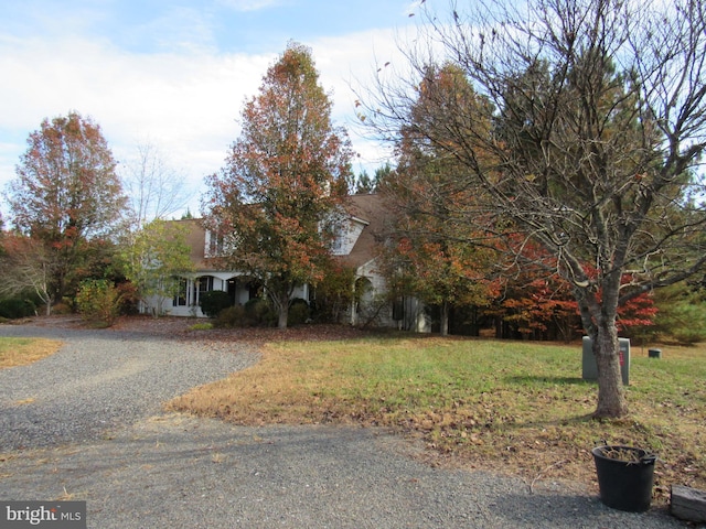 obstructed view of property with a front yard