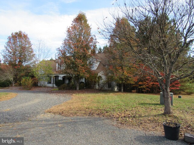 obstructed view of property featuring a front yard