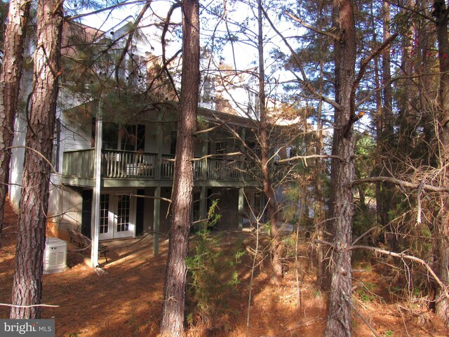 rear view of house with a deck and french doors