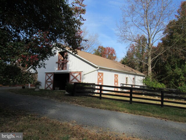 view of front of home featuring an outbuilding