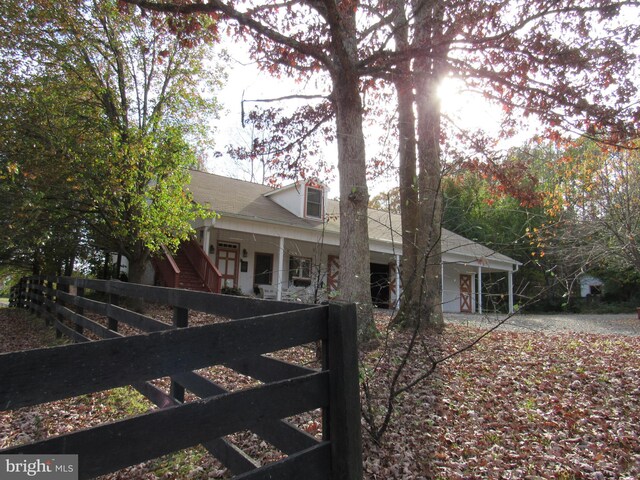 view of side of home with a porch