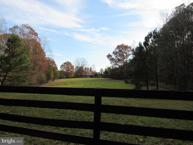 view of gate with a rural view