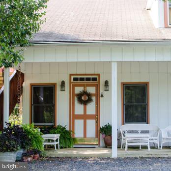 view of exterior entry with covered porch