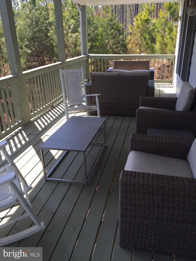 wooden deck featuring an outdoor living space