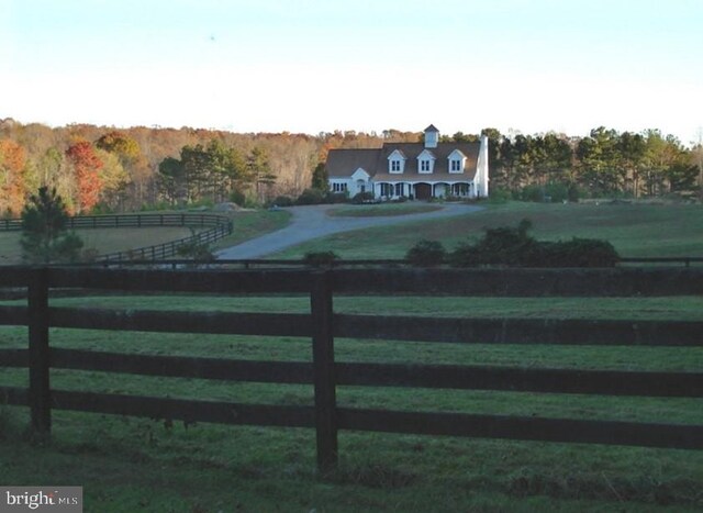 view of gate with a rural view