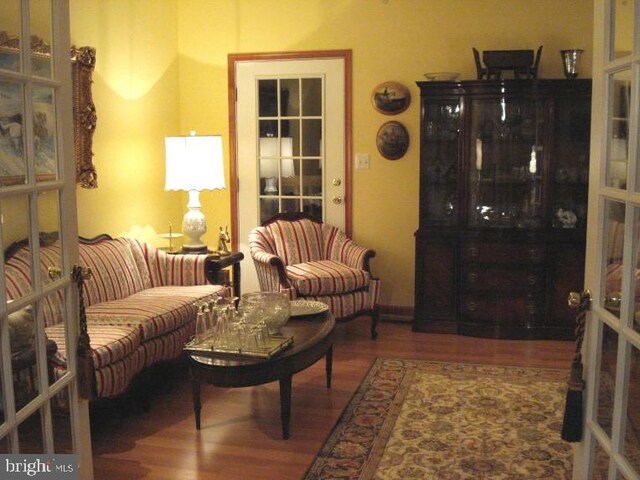 living room with hardwood / wood-style floors and french doors