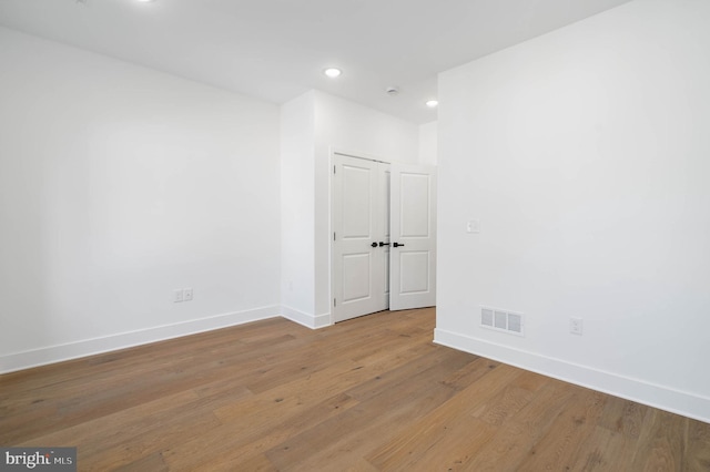 empty room with hardwood / wood-style floors